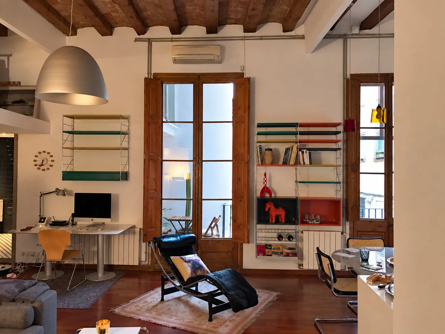 TrF living area with timber beam ceiling, French shutters and colourful modular shelving