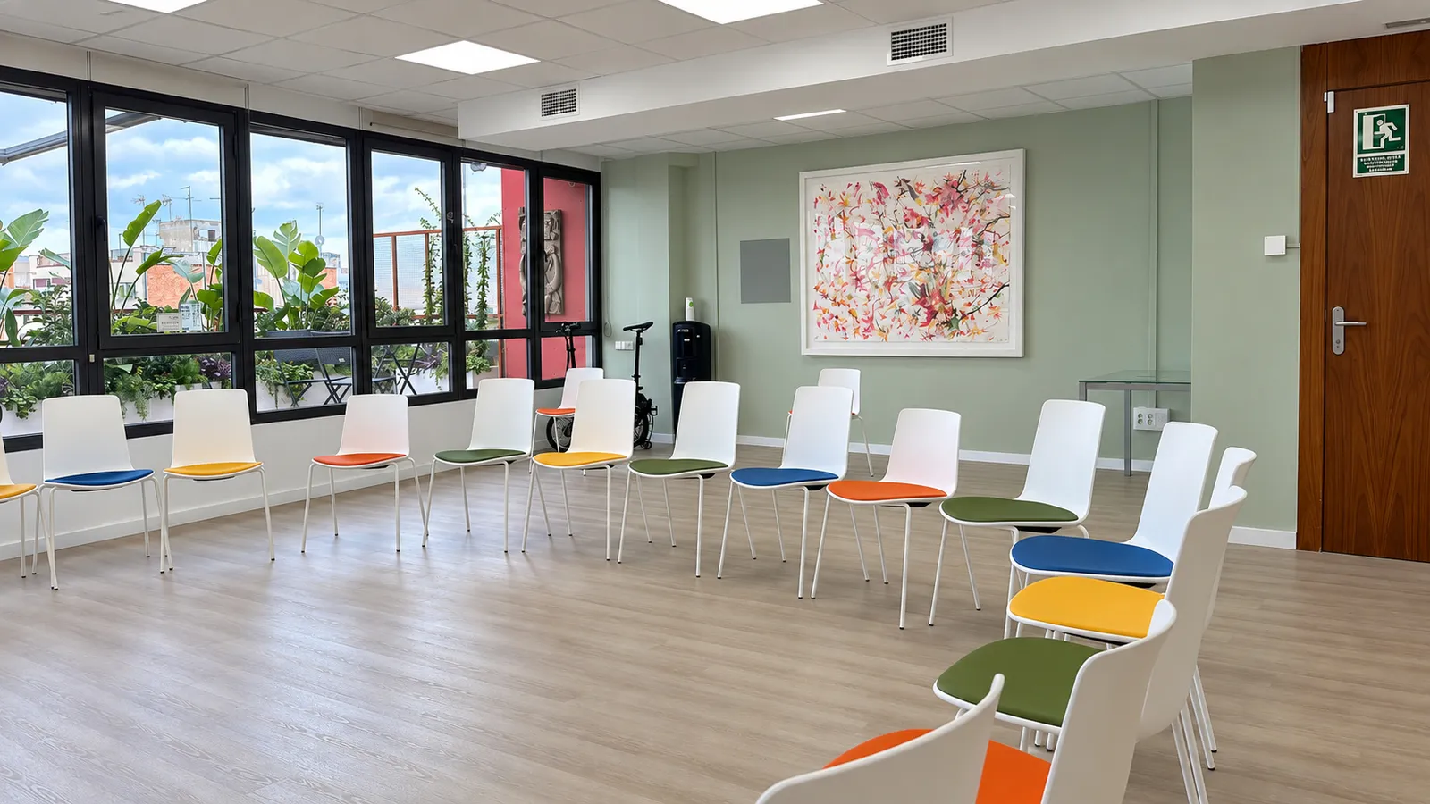 GlG training room with rows of colourful chairs and a large framed artwork
