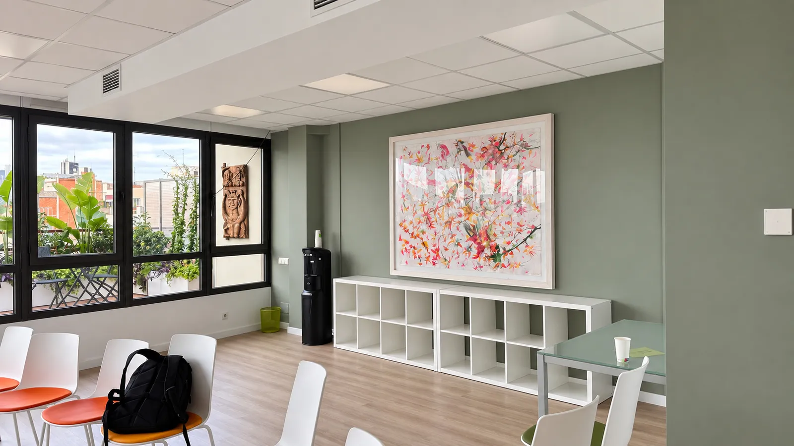 GlG training room with white shelving, framed artwork and folding windows onto the terrace